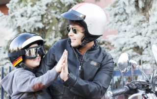 child riding on the back of a motorcycle